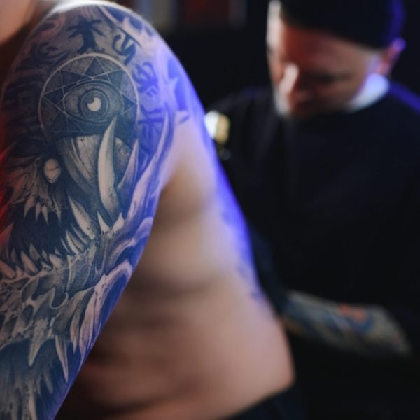 tattooing-man-creating-a-picture-on-his-back-by-a-2024-11-14-17-20-45-utc-scaled